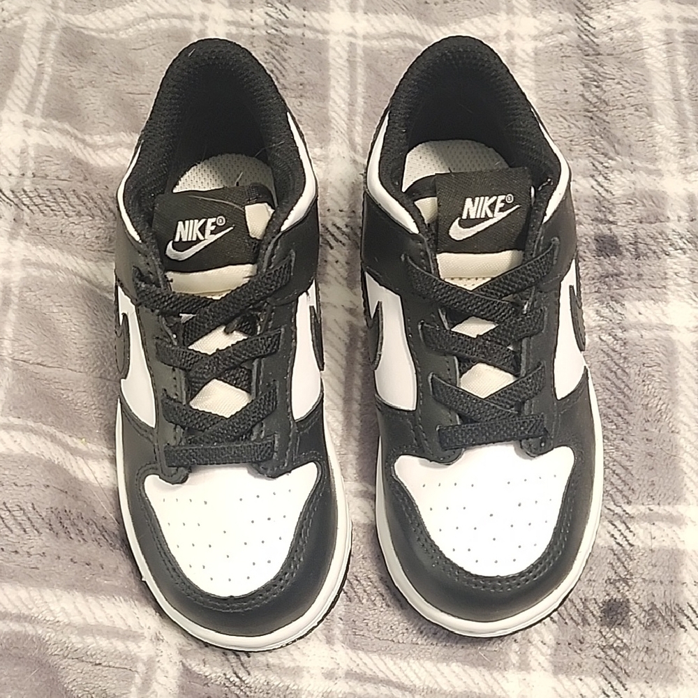Nike Black and White Sneakers with Prominent Swoosh and Low-Top Design
